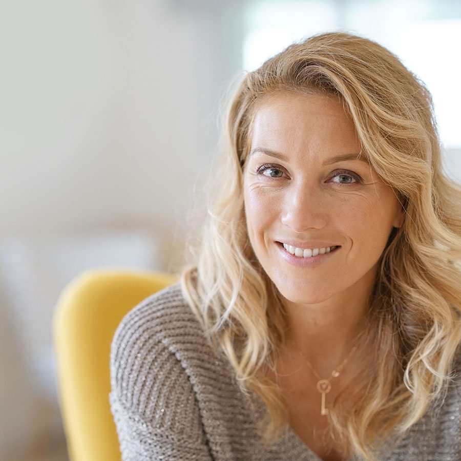 A woman with blond hair smiling